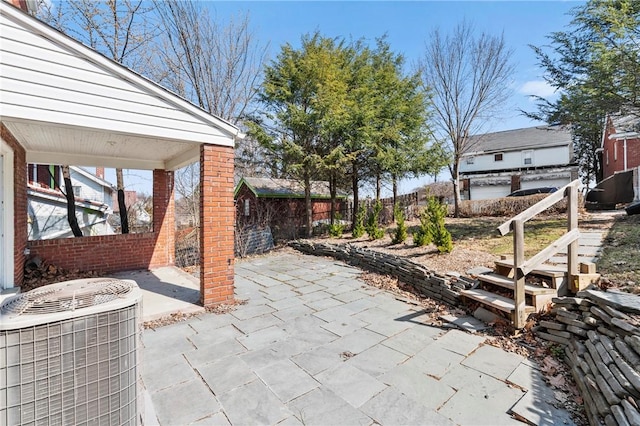 view of patio featuring central AC unit and a fenced backyard