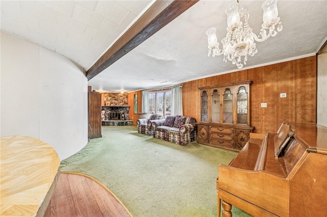 carpeted living area with beam ceiling, a chandelier, and a fireplace