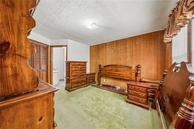 bedroom with a textured ceiling and carpet