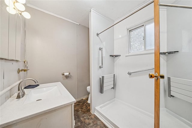 full bathroom featuring toilet, crown molding, vanity, and a shower