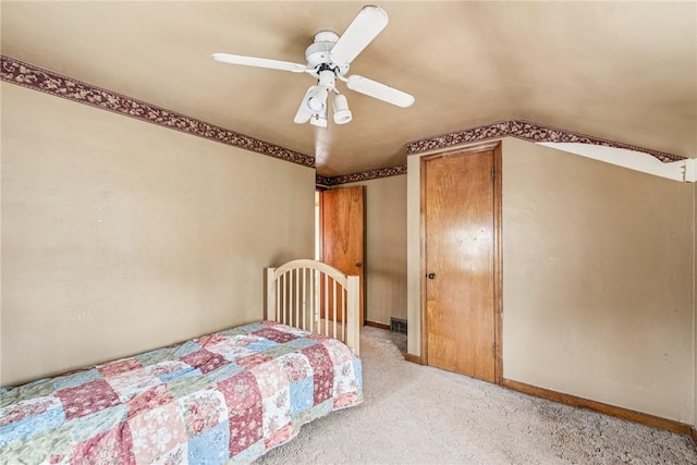 bedroom with visible vents, light carpet, baseboards, ceiling fan, and vaulted ceiling