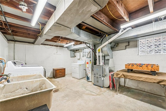 unfinished basement featuring a sink, electric panel, heating unit, water heater, and washing machine and clothes dryer