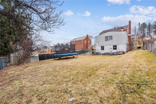 view of yard with a fenced backyard and a trampoline