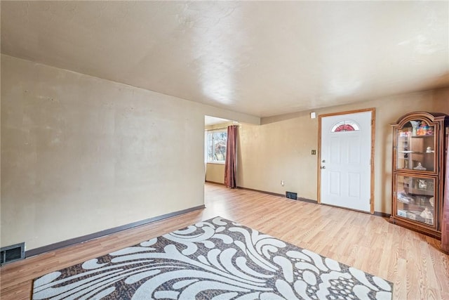 entrance foyer featuring baseboards, visible vents, and light wood finished floors