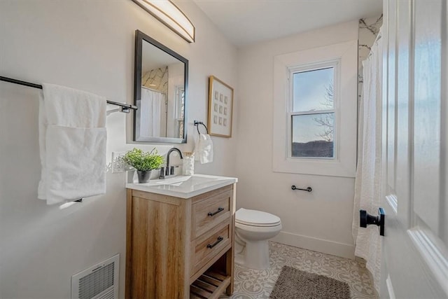 bathroom with visible vents, toilet, tile patterned flooring, baseboards, and vanity