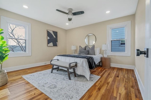 bedroom with recessed lighting, wood finished floors, and baseboards