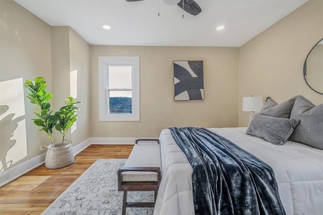 bedroom featuring a ceiling fan, recessed lighting, wood finished floors, and baseboards