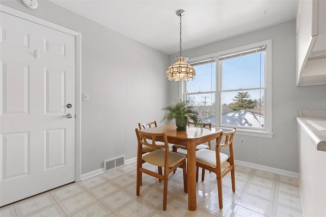 dining space with visible vents, baseboards, and light floors