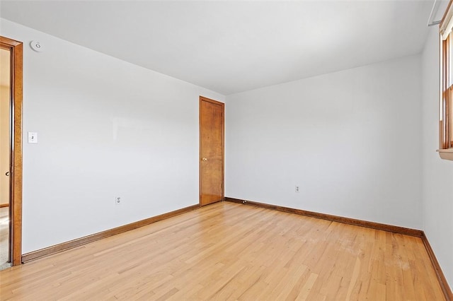 unfurnished room featuring light wood-style flooring and baseboards