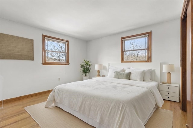 bedroom featuring light wood-type flooring and baseboards