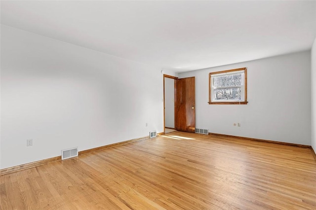 empty room with visible vents and light wood-style flooring