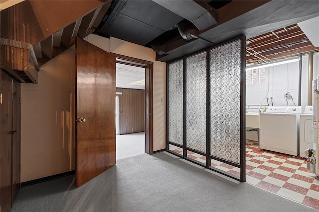 basement with tile patterned floors and separate washer and dryer