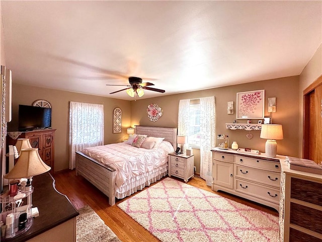 bedroom with light wood-type flooring and a ceiling fan