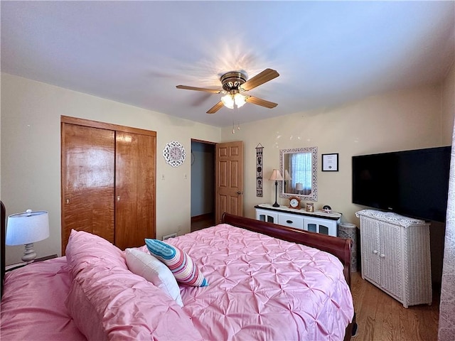 bedroom with a closet, ceiling fan, and light wood finished floors