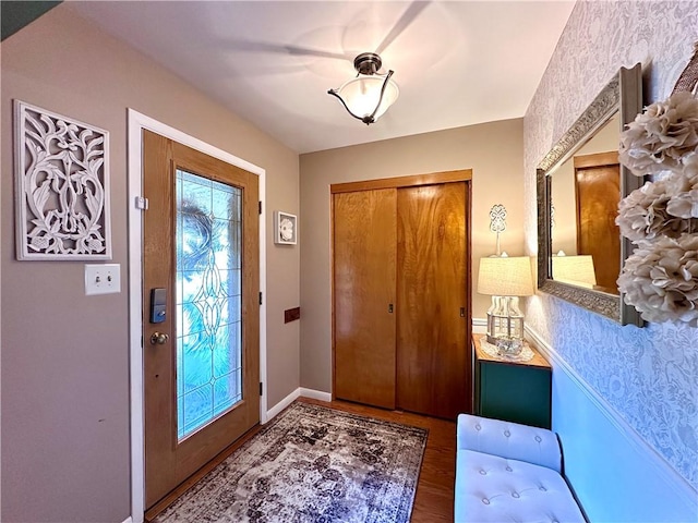 entrance foyer featuring baseboards and wood finished floors