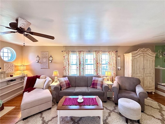 living room with wood finished floors and ceiling fan