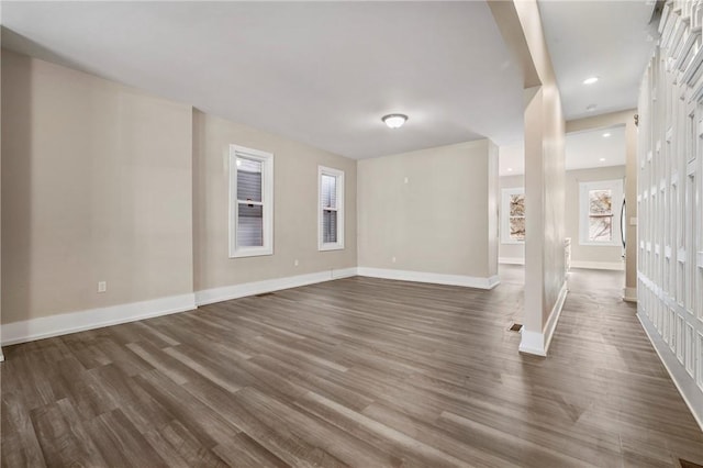 interior space featuring recessed lighting, baseboards, and dark wood-style flooring