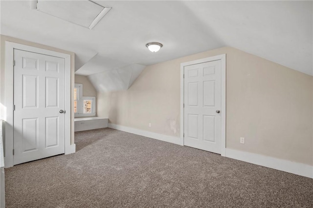 bonus room with attic access, baseboards, carpet, and vaulted ceiling