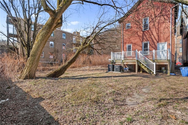 rear view of property with a deck, stairway, and central AC unit