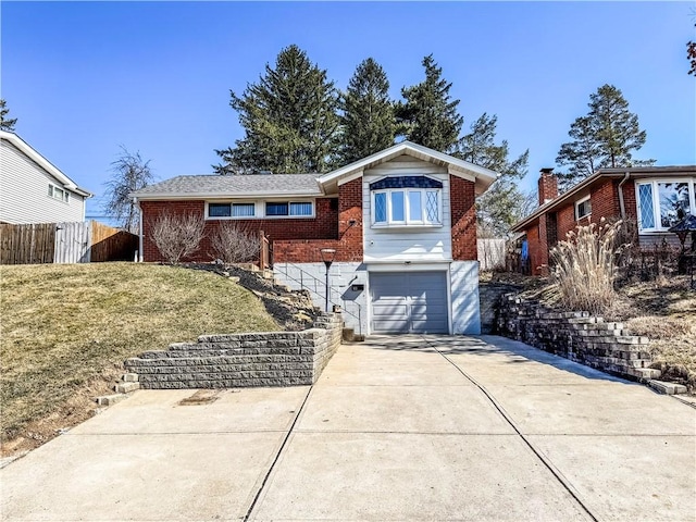 ranch-style house with a front lawn, fence, concrete driveway, a garage, and brick siding