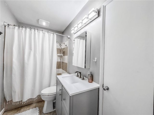 bathroom with tile patterned floors, shower / bath combo with shower curtain, toilet, and vanity