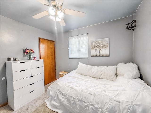 bedroom featuring light carpet and a ceiling fan