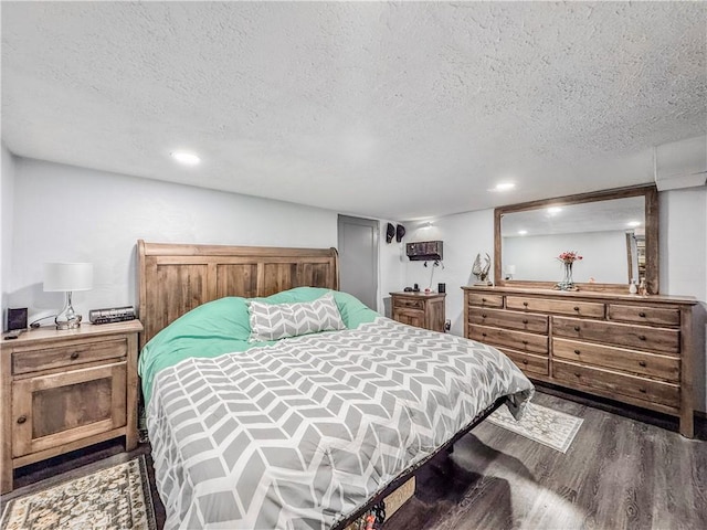 bedroom featuring a textured ceiling and wood finished floors