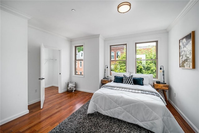 bedroom featuring baseboards, dark wood-style flooring, and crown molding