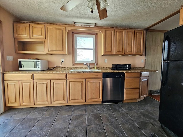 kitchen with a sink, stainless steel dishwasher, freestanding refrigerator, white microwave, and ceiling fan