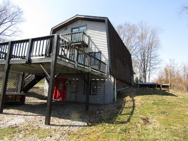 back of house with stairs, a lawn, brick siding, and a wooden deck