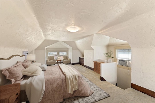 bedroom with cooling unit, lofted ceiling, a textured ceiling, and multiple windows