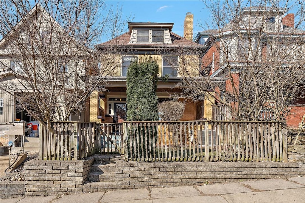 traditional style home with brick siding and a chimney