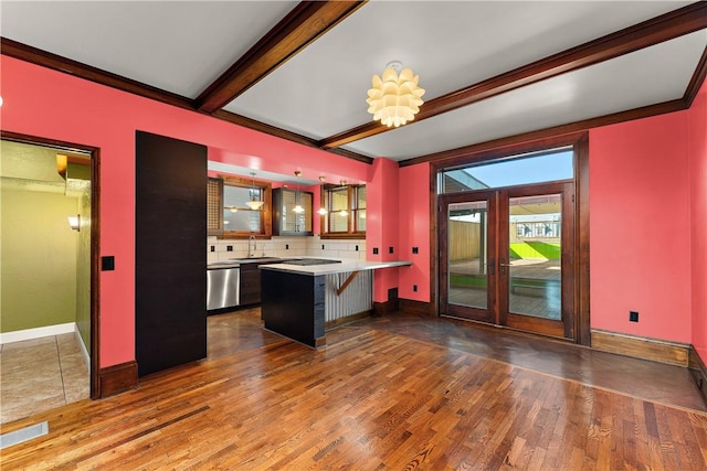 kitchen featuring beamed ceiling, hardwood / wood-style flooring, french doors, a peninsula, and decorative backsplash