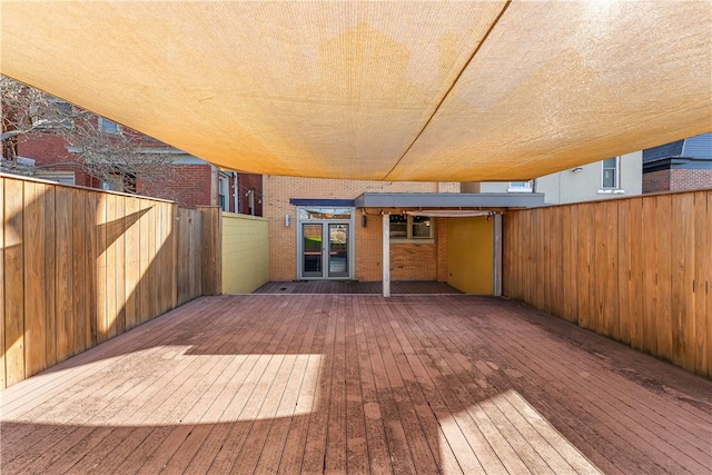 wooden terrace featuring fence