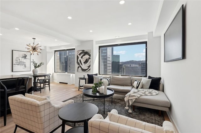 living room with a view of city, recessed lighting, and wood finished floors