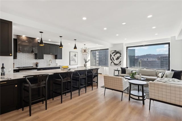 living room with recessed lighting and light wood-type flooring