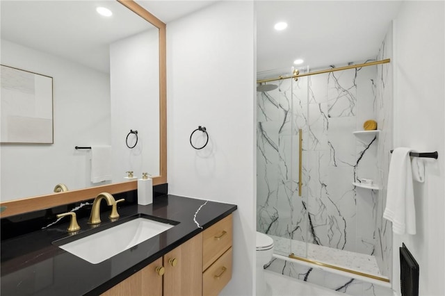 bathroom with recessed lighting, toilet, vanity, and a marble finish shower