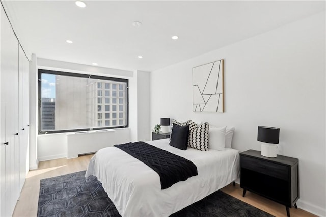 bedroom featuring recessed lighting and wood finished floors