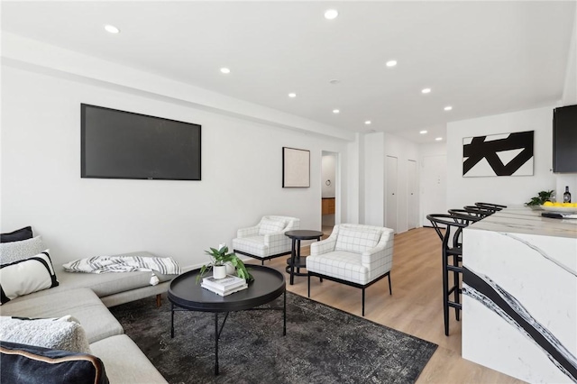 living room with recessed lighting and light wood-style flooring