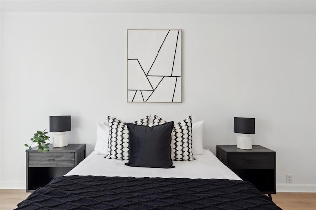 bedroom with wood finished floors and baseboards