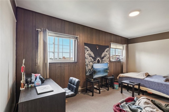 carpeted bedroom featuring wooden walls