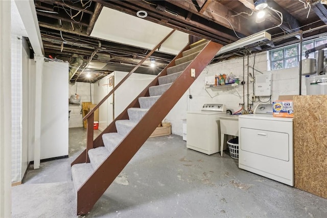 below grade area featuring stairway and separate washer and dryer