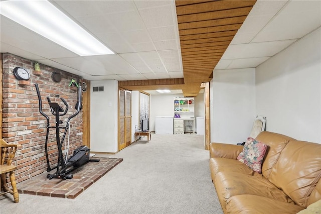 interior space featuring visible vents, a paneled ceiling, and carpet flooring