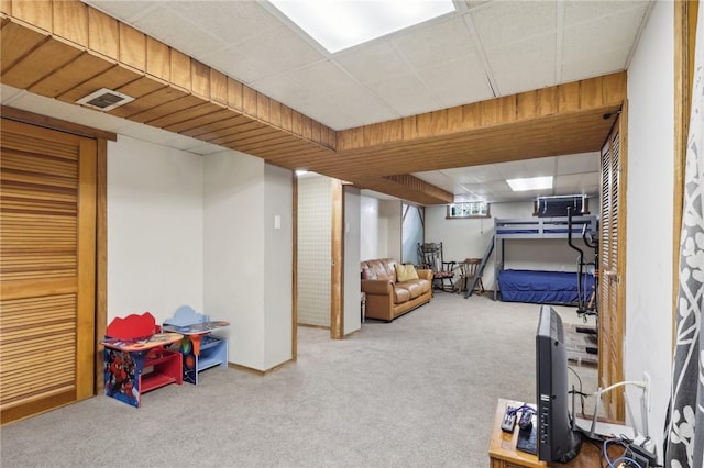 bedroom with visible vents, a paneled ceiling, and carpet flooring