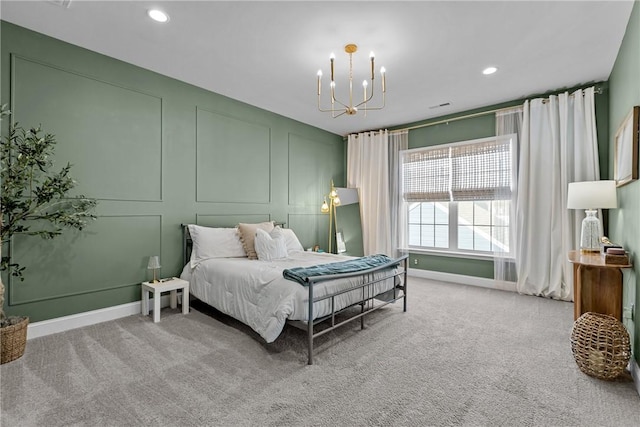 carpeted bedroom featuring recessed lighting, baseboards, an inviting chandelier, and a decorative wall