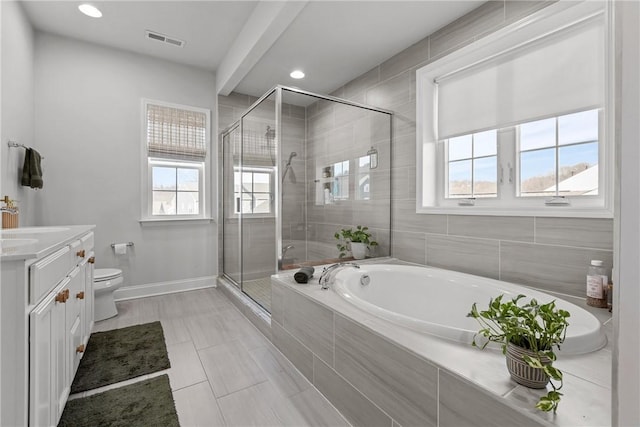 bathroom featuring visible vents, a shower stall, toilet, a garden tub, and vanity