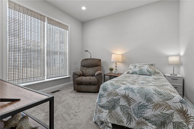 bedroom with multiple windows, visible vents, baseboards, and carpet floors