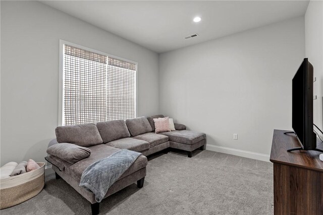 carpeted living area with visible vents, recessed lighting, and baseboards