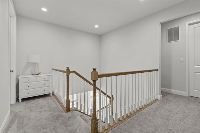 hallway with visible vents, an upstairs landing, recessed lighting, carpet floors, and baseboards