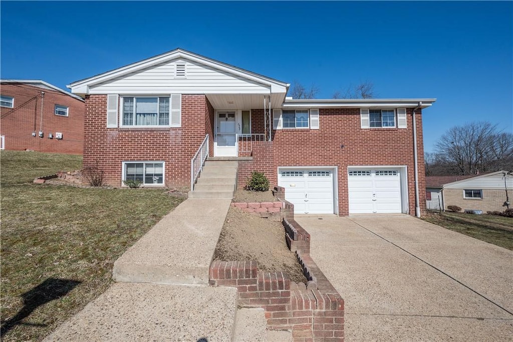 view of front of property with a garage, brick siding, concrete driveway, and a front lawn